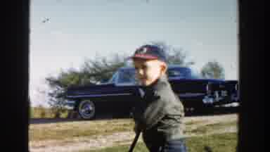 Michigan (1958): Small Boy With A Baseball Hat Playing Outside Near A Black Car