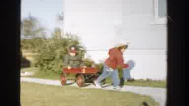 Michigan (1958): A Young Child Pulls A Red Wagon With Another Child In It