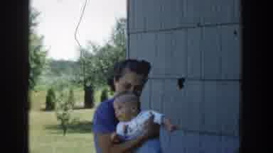 Michigan (1958): Mother Carrying Her Baby Boy