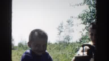 Michigan (1958): Two Boys Playing Together Around A Tree With Fruits