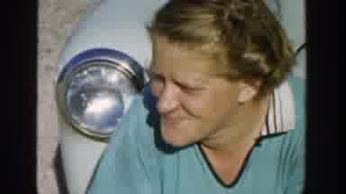 Michigan (1958): Woman Wearing Green Shirt Smiles And Winks Eye At Camera On A