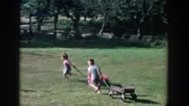Michigan (1958): White Children Playing In Big Green Yard Pulling Red Wagons