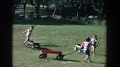 Michigan (1958): Children Playing On The Field Dragging Wheelbarrows With Their