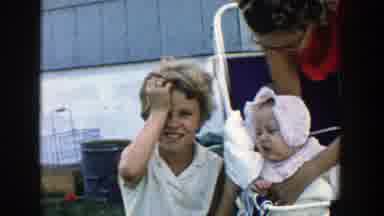 Michigan (1958): A Little Kid Sitting By His Baby Sister And Their Mom With A Big