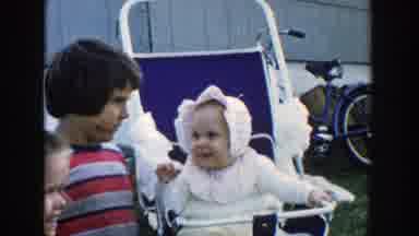 Michigan (1958): A Little Girl Earring A Baby With Some Other Kids And A Blue Bike