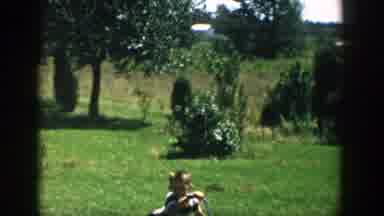 Michigan (1958): Boy Wearing Black Shorts Falls Off Blue Bicycle On A Bright Sunny