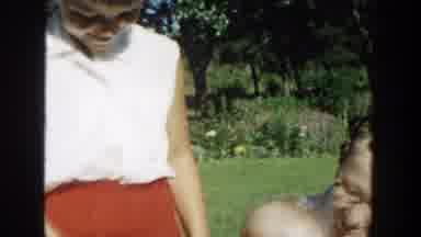 Michigan (1958): Girl Wearing Red Skirt Sits Next To Woman Wearing White Shirt And