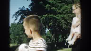 Michigan (1958): Two Kids And Their Dad Playing With Kittens In The Garden