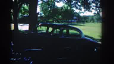 Michigan (1958): A Shirtless Man Washing A Parked Car Under The Tree