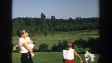 Michigan (1958): A Woman Turns Holding A Baby While A Young Girl Points And Smells