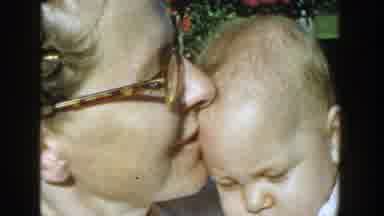 Michigan (1958): Mother Kissing Baby And Holding The Child While Outside On A Warm