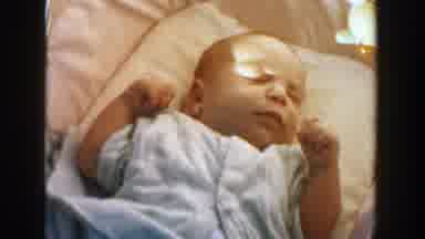 Michigan (1958): Infant Wearing Light Blue Shirt Sleeps On White Blanket In Shade
