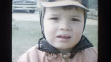 Michigan (1958): Video Of A Young Boy Wearing A Orange And Black Jacket And Cap