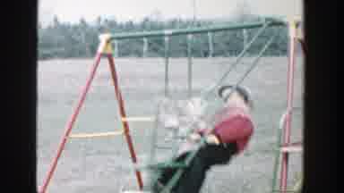 Michigan (1958): Two Children Having Fun On A Swing As They Compete With Each