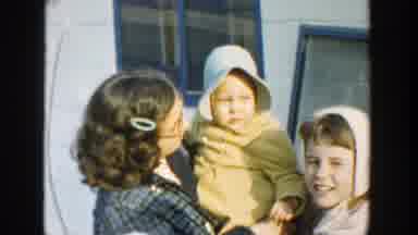 Michigan (1958): A Girl Earring A Baby With Some Other Kids Walking Next To Her