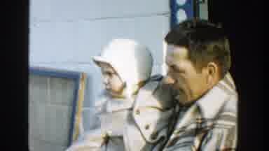 Michigan (1958): Man In A Plaid Jacket Holding A Baby Wearing A Buttoned Up Jacket