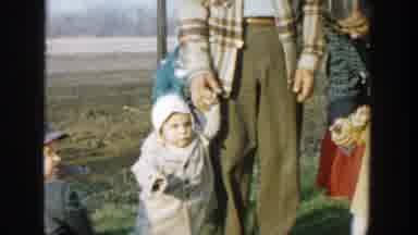 Michigan (1958): Two Toddlers Walking Holding Their Grandparents Hands Down The