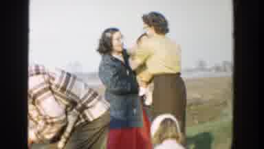 Michigan (1958): Woman Hands Child To Another Woman On A Rural Farm