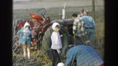 Michigan (1958): A Red Tractor Sitting In A Dirt Field With Several Children And
