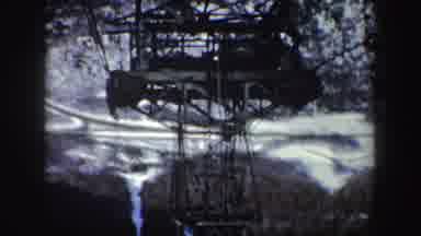 New York (1962): Inverted View Of Red Sky Tram Snow Covered Mountains And Trees On