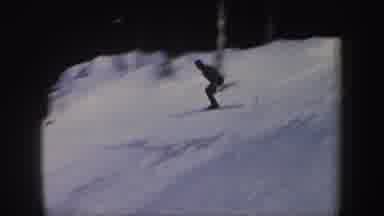 New York (1962): Person Riding Skis Down Snowy Mountain And Jumps Over A Small