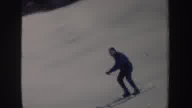 New York (1962): Male Skier In Blue Coat Making Wide Turns While Skiing Down The