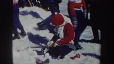 New York (1962): Child Cleans Their Skis While An Adult Walks Up A Ski Jump