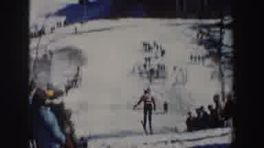 New York (1962): Sportsmen Skating On Ice With Long Skateboards As Fan Watch In