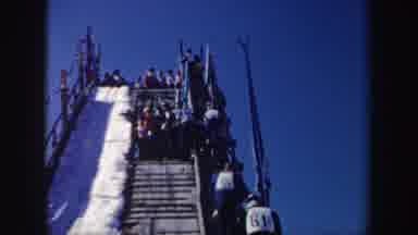 New York (1962): Skiers Walking Up Ski Jump Ramp To The Top And Skiers Skiing Down