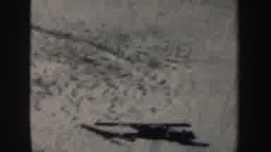 New York (1962): Person Wearing Blue Pants Jumps On Skis On A Sunny Day