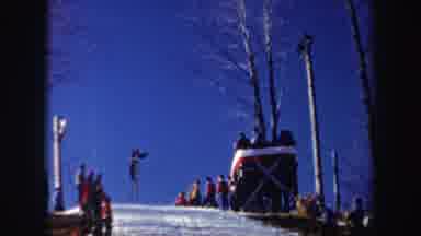 New York (1962): A Person On Skis Going Off A Large Jump And Landing As Several