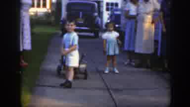 Massachusetts (1949): Three Girls In Dresses Walking By A Boy Holding Onto A Wagon