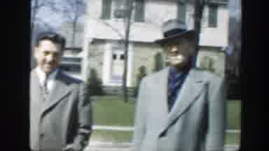 Massachusetts (1949): Two Men In Ash-Colored Jackets Waving At A Little Girl