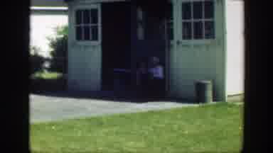 Massachusetts (1949): A Young Girl In A Yellow Dress Stands Near A Man In A Suit