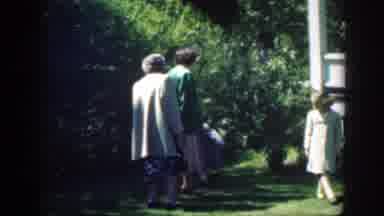 Massachusetts (1949): Girl Wearing Tan Coat Rubs Eyes While Walking On Green Grass