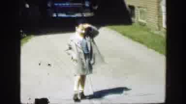 Massachusetts (1949): A Girl Holds A Hand Bag As She Walks Past Her Brother