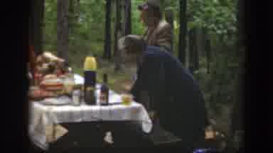 Massachusetts (1949): Four People Setting Up Items On Picnic Table On A Cloudy Day