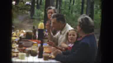 Massachusetts (1949): People Eating At Picnic Table While Small Boy Wearing Red