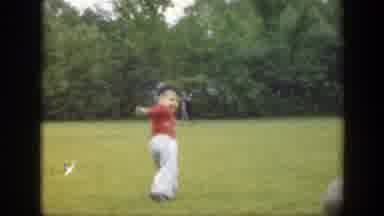 Massachusetts (1949): A Little Kid Is Playing With A Ball Outside In The Daytime