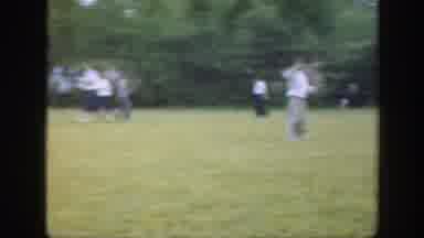 Massachusetts (1949): Man Wearing White Shirt Rolls Gray Ball On Green Grass On A