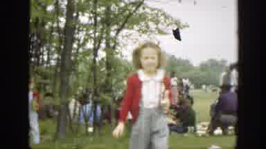 Massachusetts (1949): Girl Wearing Red Sweater Holds Pink Object On A Clear Day