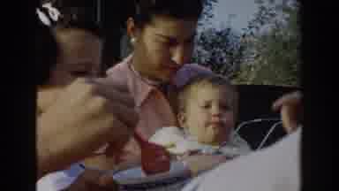 Glendale California (1962): Mother Feeding Her Young Child Sitting In Her Lap With