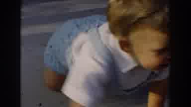 Glendale California (1962): Baby Crawling On Ground Adult Woman Wearing Red