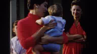 Glendale California (1962): Woman Wearing Red Shirt Holds Toddler Wearing Blue