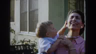 Glendale California (1962): A Child In A Woman's Arms Tries To Take Her Earrings