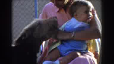 Glendale California (1962): Mother Holding A Baby And A Dog Coming Up To Nuzzle