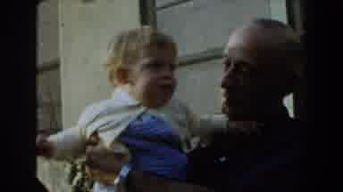 Glendale California (1962): An Old Man Wearing A Watch Plays With A Young Child In