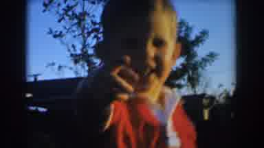 Glendale California (1962): A Kid Is Full Of Smiles As He Plays By Hiding In The