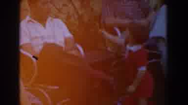 Glendale California (1962): Toddler In Red Outfit Holds Up Toy To Guest At Party