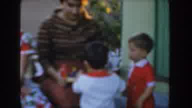 Glendale California (1962): Woman Wearing Brown Shirt Looks At Toddler Wearing